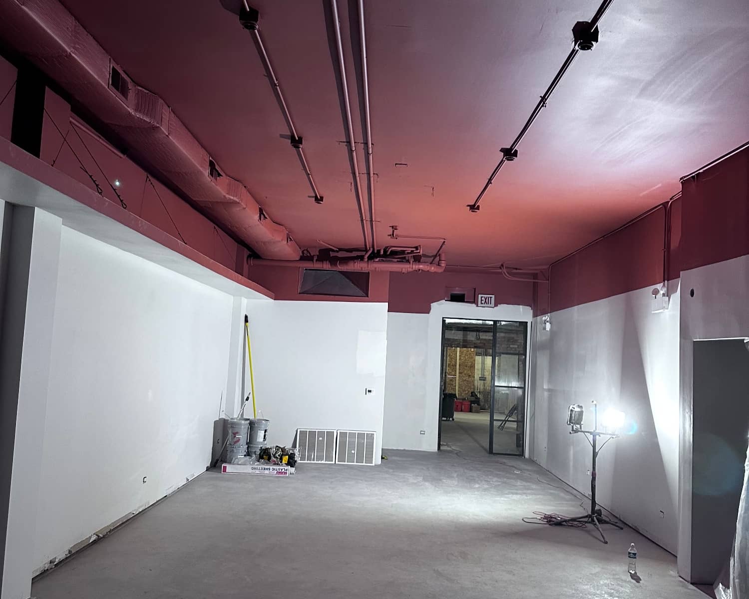 commercial building with red ceiling and white walls