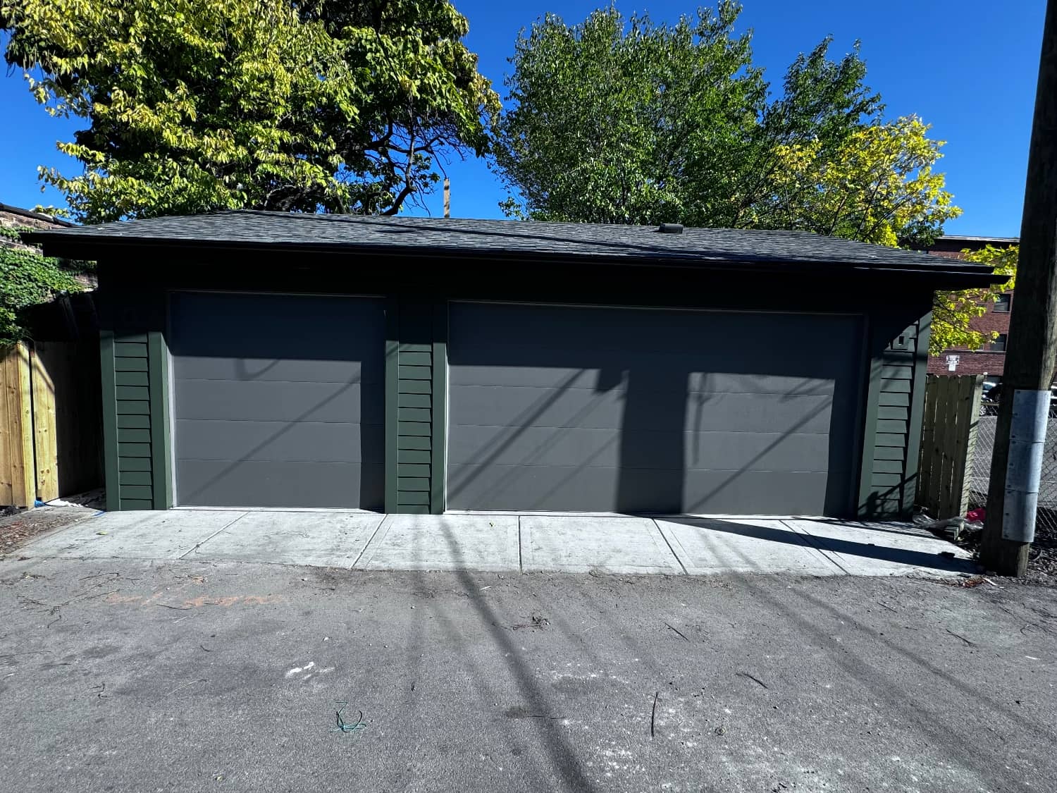 green painted garage and gray garage doors